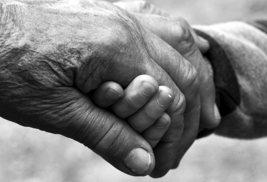 Close up of elderly person holding hands