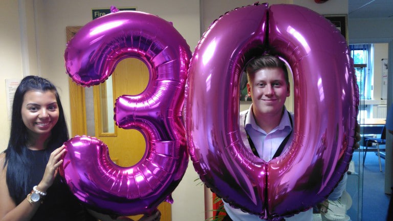 Staff with 30 years balloons