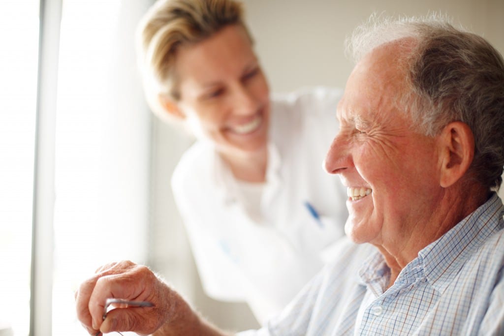 An elderly man talking to his social care worker