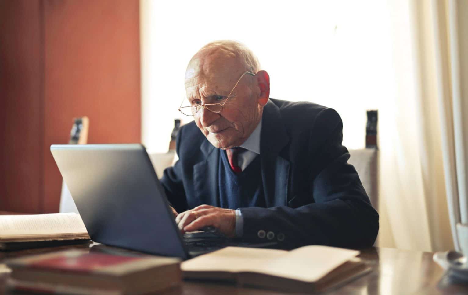 Older dad sat down using his laptop