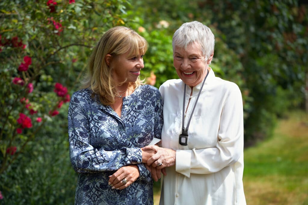 elderly woman and daughter walking outside