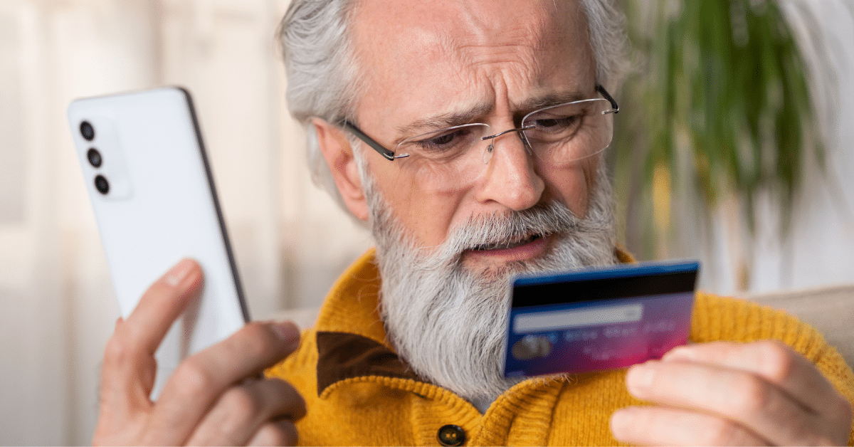 Man on phone holding credit card