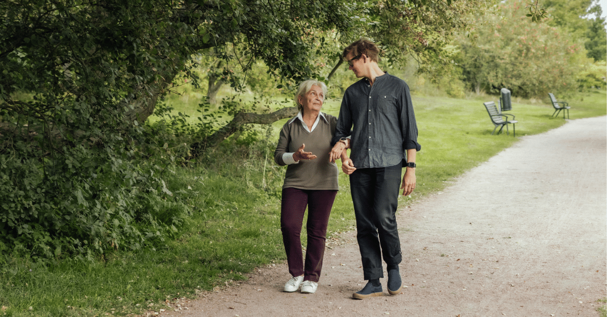 mother and son walking in park