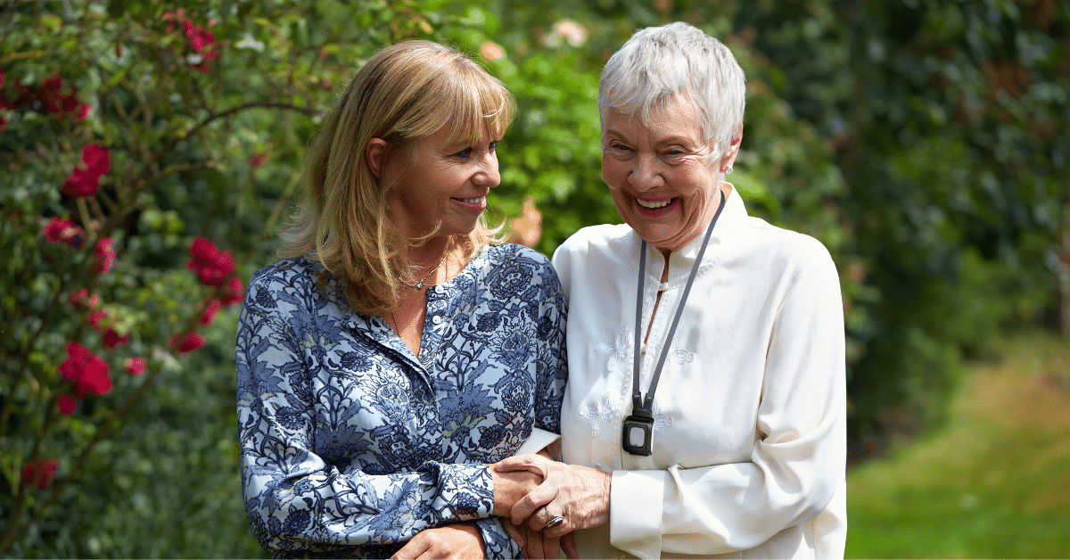 older woman walking with younger woman outside