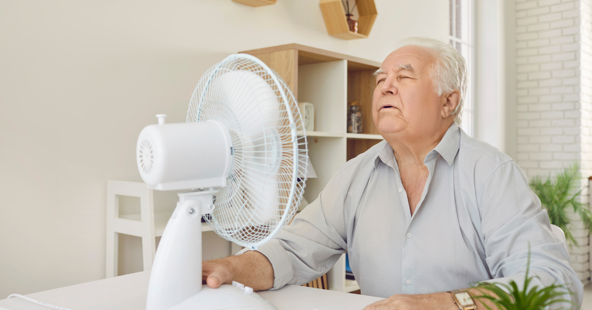 Man in front of fan in hot weather